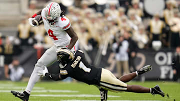 Ohio State Buckeyes wide receiver Jeremiah Smith (4) runs over Purdue Boilermakers defensive back Smiley Bradford (1) during the NCAA football game at Ross-Ade Stadium in West Lafayette, Ind. on Nov. 8, 2025.
