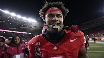 Ohio State Buckeyes safety Caleb Downs leaves the field with a rose in his mouth following the 42-17 win over the Tennessee Volunteers in the College Football Playoff first round game at Ohio Stadium in Columbus on Dec. 21, 2024. Ohio State will face Oregon in the Rose Bowl.