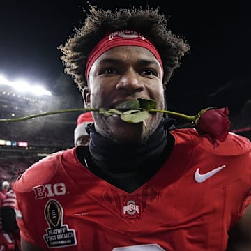 Ohio State Buckeyes safety Caleb Downs leaves the field with a rose in his mouth following the 42-17 win over the Tennessee Volunteers in the College Football Playoff first round game at Ohio Stadium in Columbus on Dec. 21, 2024. Ohio State will face Oregon in the Rose Bowl.