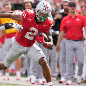 Aug 31, 2024; Columbus, OH, USA; Ohio State Buckeyes wide receiver Emeka Egbuka (2) gives Akron Zips cornerback Darrian Lewis (24) a stiff arm during the first half of the NCAA football game at Ohio Stadium.