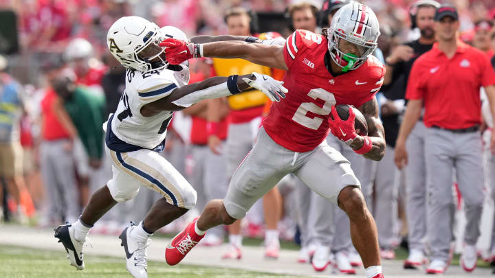 Aug 31, 2024; Columbus, OH, USA; Ohio State Buckeyes wide receiver Emeka Egbuka (2) gives Akron Zips cornerback Darrian Lewis (24) a stiff arm during the first half of the NCAA football game at Ohio Stadium.