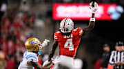 Ohio State Buckeyes wide receiver Jeremiah Smith (4) makes a one-handed catch in front of UCLA Bruins defensive back Andre Jordan Jr. (2) during the NCAA football game at Ohio Stadium in Columbus on Nov. 15, 2025.