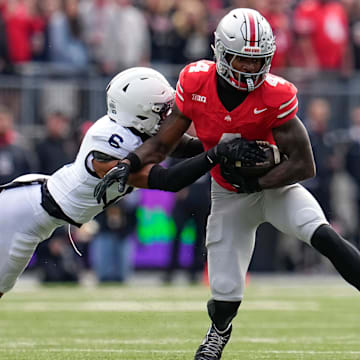 Ohio State Buckeyes wide receiver Jeremiah Smith (4) catches a pass in front of Penn State Nittany Lions safety Zakee Wheatley (6) during the NCAA football game at Ohio Stadium in Columbus on Nov. 1, 2025.