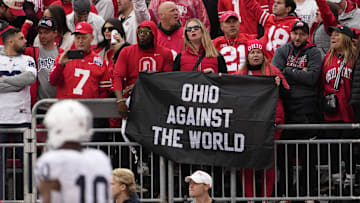 Oct 21, 2023; Columbus, Ohio, USA; Ohio State Buckeyes fans hold an “Ohio against the world” sign during the NCAA football game against the Penn State Nittany Lions at Ohio Stadium.