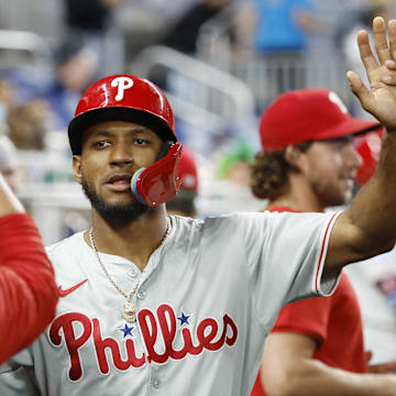 Sep 8, 2024; Miami, Florida, USA;  Philadelphia Phillies center fielder Johan Rojas (18) celebrates in the dugout after scoring against the Miami Marlins in the ninth inning at loanDepot Park. 