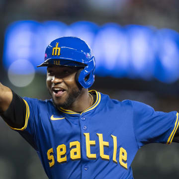 Jun 14, 2024; Seattle, Washington, USA; Seattle Mariners left fielder Victor Robles (10) celebrates after hitting a bunt single during the fourth inning against the Texas Rangers at T-Mobile Park. Mandatory Credit: Stephen Brashear-USA TODAY Sports