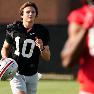 Aug 1, 2024; Columbus, OH, USA; Ohio State Buckeyes quarterback Julian Sayin (10) runs between drills during football camp at the Woody Hayes Athletic Complex.