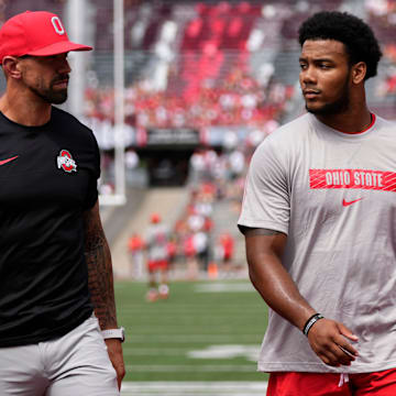 Aug 31, 2024; Columbus, OH, USA; Ohio State Buckeyes linebackers coach James Laurinaitis talks to linebacker C.J. Hicks (11) prior to the NCAA football game against the Akron Zips at Ohio Stadium. Ohio State won 52-6.