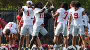 Aug 1, 2024; Columbus, OH, USA; Ohio State Buckeyes cornerback Davison Igbinosun (1), cornerback Denzel Burke (10), cornerback Jordan Hancock (7) and safety Lathan Ransom (8) do a handshake during football camp at the Woody Hayes Athletic Complex.