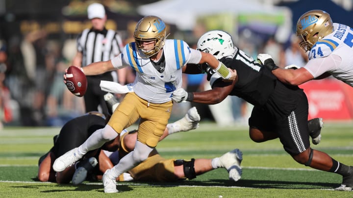 Aug 31, 2024; Honolulu, Hawaii, USA; UCLA Bruins quarterback Ethan Garbers (4) scrambles away from Hawaii Rainbow Warriors defensive lineman Dion Washington (19) during the fourth quarter of an NCAA college football game at the Clarence T.C. Ching Athletics Complex. Mandatory Credit: Marco Garcia-USA TODAY Sports