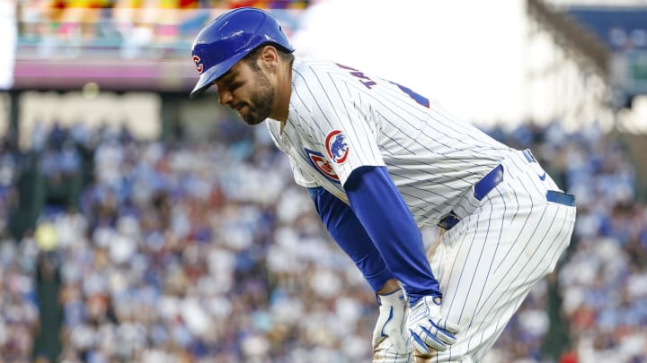 Jun 17, 2024; Chicago, Illinois, USA; Chicago Cubs outfielder Mike Tauchman (40) reacts after injuring his leg after running to first base after hitting a single against the San Francisco Giants during the third inning at Wrigley Field.