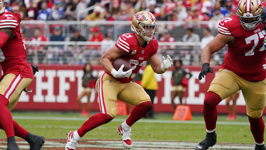 Christian McCaffrey runs with the ball for the 49ers