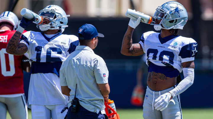 Aug 1, 2023; Oxnard, CA, USA; Dallas Cowboys wide receiver Jalen Moreno-Cropper (16) and wide receiver Tyron Billy-Johnson (80) hydrate during training camp at Marriott Residence Inn-River Ridge playing fields. 