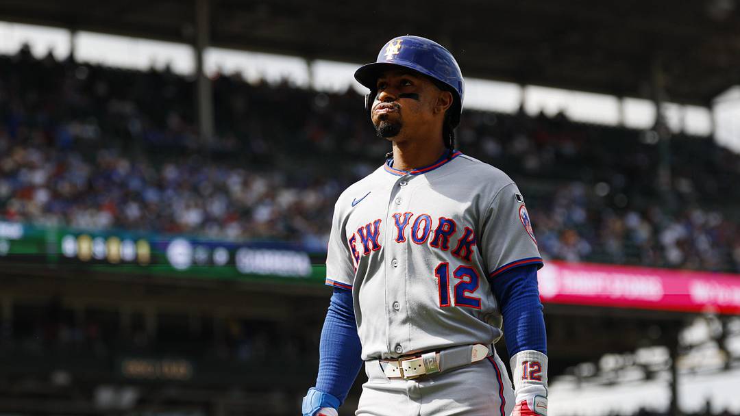New York Mets shortstop Francisco Lindor (12) walks back to the dugout after flying out against the Chicago Cubs during the sixth inning at Wrigley Field.