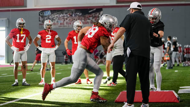 Coach works with receivers and tight ends in practice.