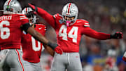 Ohio State Buckeyes defensive end JT Tuimoloau (44) and safety Sonny Styles (6) celebrates a defensive stop during the first half of the Cotton Bowl Classic College Football Playoff semifinal game against the Texas Longhorns at AT&T Stadium in Arlington, Texas on Jan. 10, 2025.