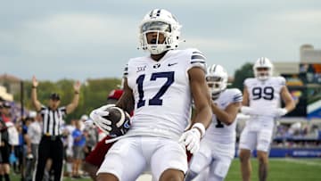 Sep 23, 2023; Lawrence, Kansas, USA; Brigham Young Cougars wide receiver Keelan Marion (17) scores a touchdown during the second half against the Kansas Jayhawks at David Booth Kansas Memorial Stadium. Mandatory Credit: Jay Biggerstaff-Imagn Images