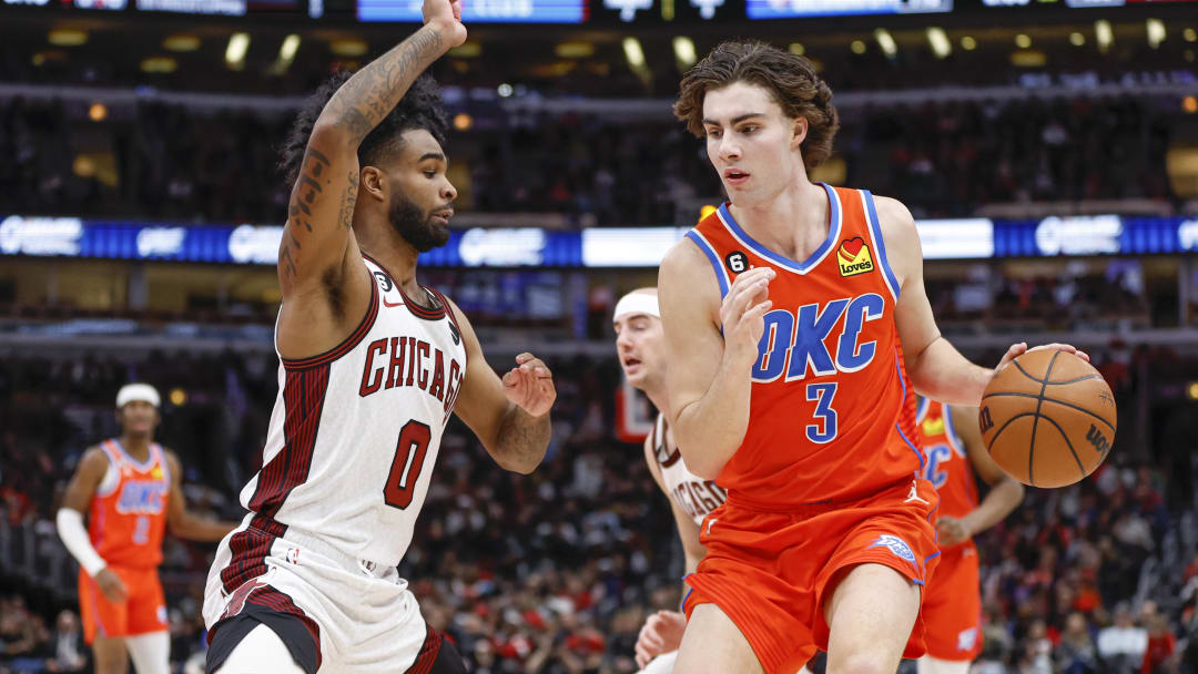 Jan 13, 2023; Chicago, Illinois, USA; Oklahoma City Thunder guard Josh Giddey (3) is defended by Chicago Bulls guard Coby White (0) during the second half at United Center. Mandatory Credit: Kamil Krzaczynski-USA TODAY Sports