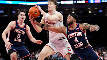 Ohio State Buckeyes center Christoph Tilly (13) muscles past Illinois Fighting Illini guard Kylan Boswell (4) and forward David Mirkovic (0) during the first half of the NCAA men's basketball game in Columbus on Dec. 9, 2025.