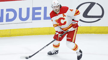 Jan 13, 2025; Chicago, Illinois, USA; Calgary Flames defenseman Rasmus Andersson (4) looks to pass the puck against the Chicago Blackhawks during the second period at United Center. Mandatory Credit: Kamil Krzaczynski-Imagn Images