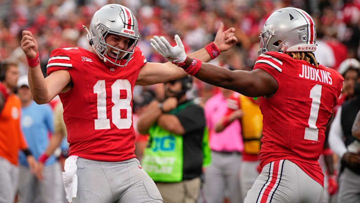 Aug 31, 2024; Columbus, OH, USA; Ohio State Buckeyes quarterback Will Howard (18) celebrates a touchdown run by running back Quinshon Judkins (1) during the second half of the NCAA football game against the Akron Zips at Ohio Stadium. Ohio State won 52-6.