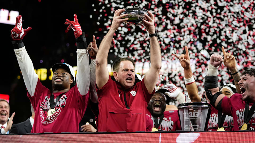 Indiana Hoosiers head coach Curt Cignetti hoists the trophy after winning the Big Ten Conference championship game against the Ohio State Buckeyes at Lucas Oil Stadium in Indianapolis on Dec. 6, 2025. Ohio State lost 13-10.