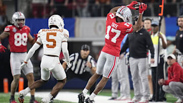 Ohio State Buckeyes wide receiver Carnell Tate (17) makes a sideline catch in front of Texas Longhorns defensive back Malik Muhammad (5) during the first half of the Cotton Bowl Classic College Football Playoff semifinal game at AT&T Stadium in Arlington, Texas on Jan. 10, 2025.