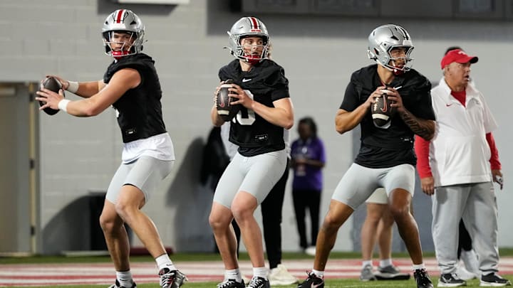 From left, Ohio State Buckeyes quarterbacks Lincoln Kienholz (3), Julian Sayin (10) and Tavien St. Clair (9) drop back to pass during spring football practice at the Woody Hayes Athletic Center in Columbus on March 19, 2025. From left, Ohio State Buckeyes quarterbacks Lincoln Kienholz (3), Julian Sayin (10) and Tavien St. Clair (9) drop back to pass during spring football practice at the Woody Hayes Athletic Center in Columbus on March 19, 2025.