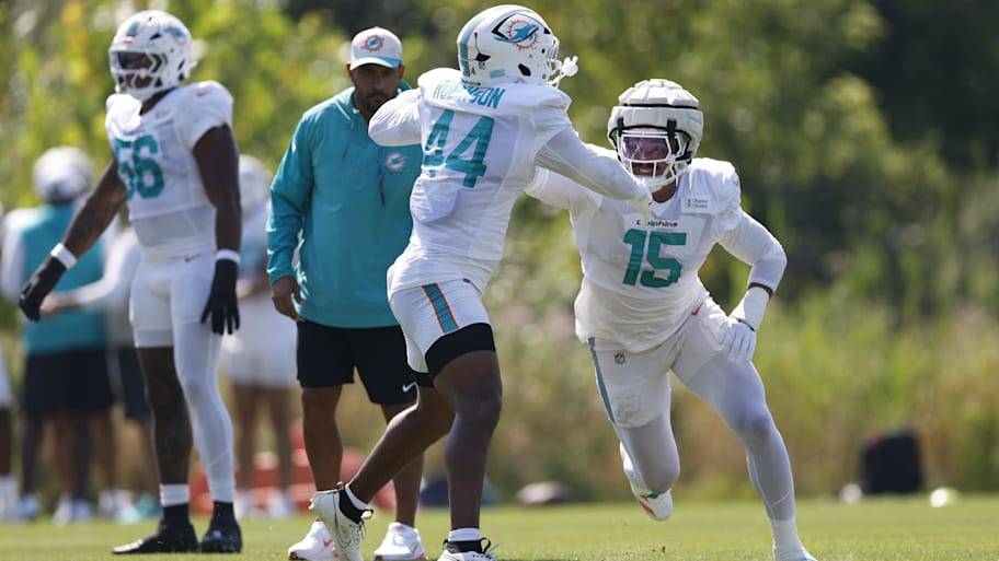 Miami Dolphins linebacker Chop Robinson (44) and linebacker Jaelan Phillips (15) run on the field before joint training camp practice with the Chicago Bears ahead of Sunday's preseason opener.  | Kamil Krzaczynski-Imagn Images