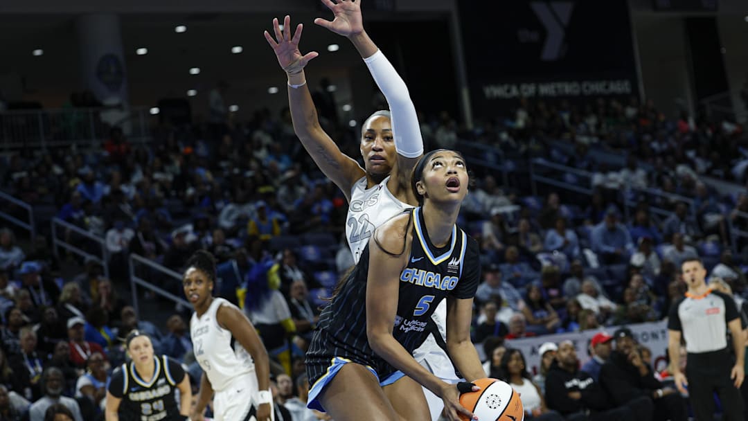 Aug 25, 2025; Chicago, Illinois, USA; Chicago Sky forward Angel Reese (5) drives to the basket against Las Vegas Aces center A'ja Wilson (22) during the first half at Wintrust Arena. Mandatory Credit: Kamil Krzaczynski-Imagn Images