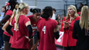 Louisville volleyball head coach Dani Busboom Kelly, right, instructs her team during a break against North Carolina in their match at the L&N Arena in Louisville, Ky. on Nov. 17, 2024. The Cards swept North Carolina in 3 sets on senior day.