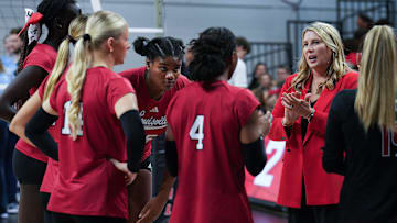 Louisville volleyball head coach Dani Busboom Kelly, right, instructs her team during a break against North Carolina in their match at the L&N Arena in Louisville, Ky. on Nov. 17, 2024. The Cards swept North Carolina in 3 sets on senior day.