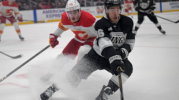 Apr 17, 2025; Los Angeles, California, USA;  Calgary Flames center Sam Morton (45) and Los Angeles Kings left wing Andrei Kuzmenko (96) vie for the puck during the second period at Crypto.com Arena. Mandatory Credit: Jayne Kamin-Oncea-Imagn Images