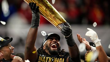 Ohio State Buckeyes wide receiver Jeremiah Smith (4) holds the trophy following the 34-23 win over the Notre Dame Fighting Irish to win the College Football Playoff National Championship at Mercedes-Benz Stadium in Atlanta on Jan. 21, 2025.
