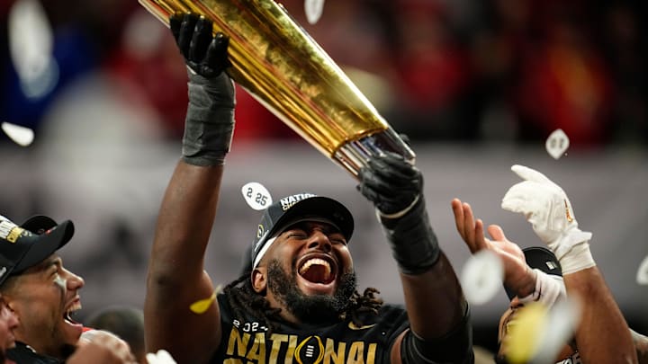 Ohio State Buckeyes wide receiver Jeremiah Smith (4) holds the trophy following the 34-23 win over the Notre Dame Fighting Irish to win the College Football Playoff National Championship at Mercedes-Benz Stadium in Atlanta on Jan. 21, 2025.