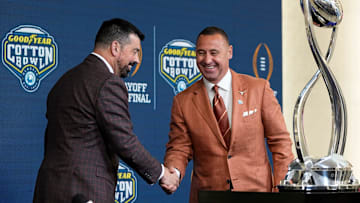 Ohio State Buckeyes head coach Ryan Day and Texas Longhorns head coach Steve Sarkisian shake hands following a press conference at AT&T Stadium prior to the College Football Playoff semifinal at the Cotton Bowl Classic in Arlington, Texas on Jan. 9, 2025.