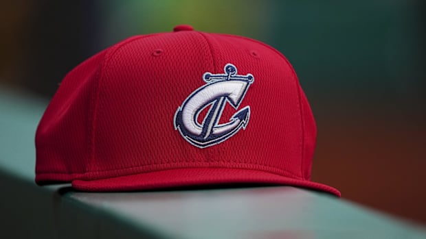 A Columbus Clippers hat sits on the dugout railing