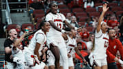 Louisville's Ja'Leah Williams (12), center, and Tajianna Roberts (22) leapt into the air as the bench erupted while a substitute scored late in their 78-52 victory over Clemson during their game at the KFC Yum! Center in Louisville, Ky. on Feb. 27, 2025.