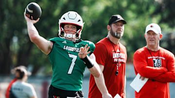 U of L QB Miller Moss (7) passes during practice as OC Brian Brohm and head coach Jeff Brohm