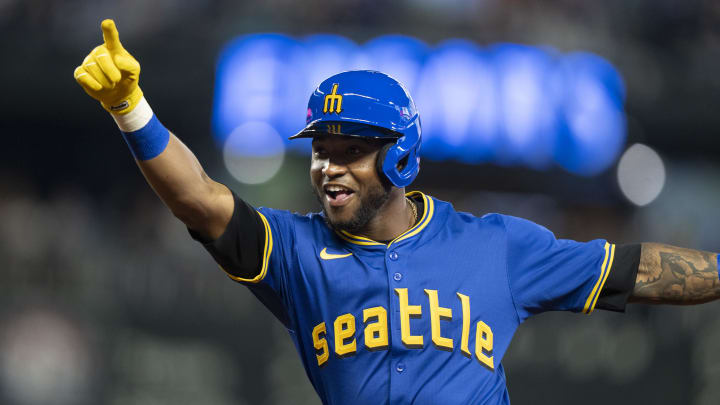 Seattle Mariners left fielder Victor Robles (10) celebrates after hitting a bunt single against the Texas Rangers on June 14 at T-Mobile Park.