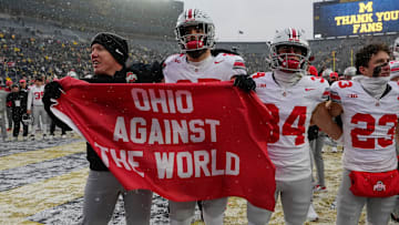 Ohio State Buckeyes tight ends coach Keenan Bailey celebrates with tight end Bennett Christian (85), wide receiver Brennen Schramm (34) and wide receiver Nolan Baudo (23) following the NCAA football game against the Michigan Wolverines at Michigan Stadium in Ann Arbor, Mich. on Nov. 29, 2025. Ohio State won 27-9.
