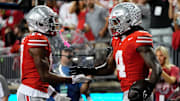 Ohio State Buckeyes wide receiver Carnell Tate (17) celebrates a touchdown by wide receiver Jeremiah Smith (4) during the first half of the NCAA football game against the Minnesota Golden Gophers at Ohio Stadium in Columbus on Oct. 4, 2025.