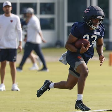 Roschon Johnson carries at Bears training camp practices. It was his goal-line runs and fight later that set the tone for physical play.