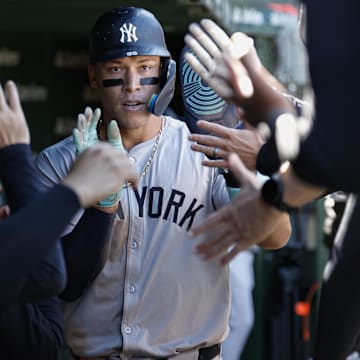 Sep 7, 2024; Chicago, Illinois, USA; New York Yankees outfielder Aaron Judge (99) celebrates with teammates in the dugout after scoring against the Chicago Cubs during the sixth inning at Wrigley Field. Mandatory Credit: Kamil Krzaczynski-Imagn Images