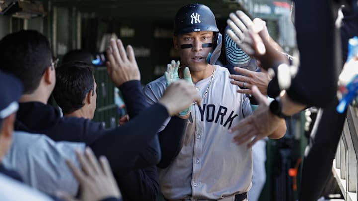 Sep 7, 2024; Chicago, Illinois, USA; New York Yankees outfielder Aaron Judge (99) celebrates with teammates in the dugout after scoring against the Chicago Cubs during the sixth inning at Wrigley Field. Mandatory Credit: Kamil Krzaczynski-Imagn Images