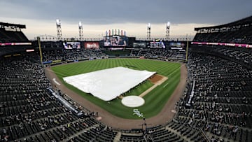 Chicago White Sox grounds crew pulls out the tarp during a rain delay on Thursday against the Cleveland Guardians at Rate Field.