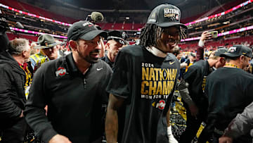 Ohio State Buckeyes head coach Ryan Day and Ohio State Buckeyes wide receiver Jeremiah Smith (4) leave the field following the 34-23 win over the Notre Dame Fighting Irish to win the College Football Playoff National Championship at Mercedes-Benz Stadium in Atlanta on Jan. 21, 2025.
