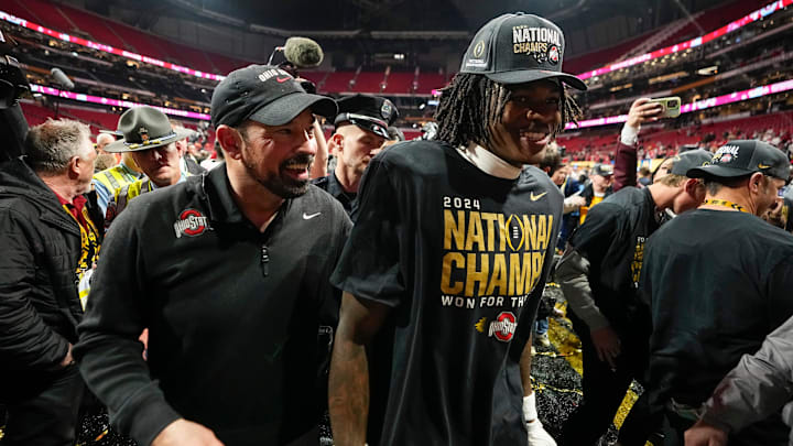 Ohio State Buckeyes head coach Ryan Day and Ohio State Buckeyes wide receiver Jeremiah Smith (4) leave the field following the 34-23 win over the Notre Dame Fighting Irish to win the College Football Playoff National Championship at Mercedes-Benz Stadium in Atlanta on Jan. 21, 2025.