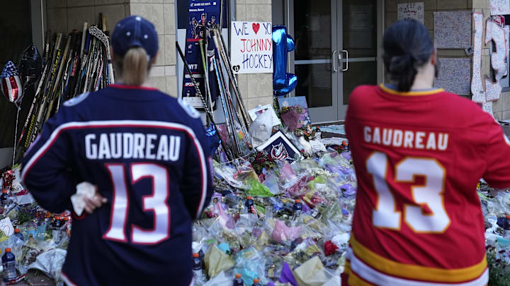 Sep 4, 2024; Columbus, OH, USA; Mourners gather for a candlelight vigil to remember Columbus Blue Jackets forward Johnny Gaudreau at Nationwide Arena. Gaudreau, along with his brother, Matthew, died in a bicycle crash last week. Mandatory Credit: Adam Cairns-Imagn Images via Columbus Dispatch/USA TODAY Network