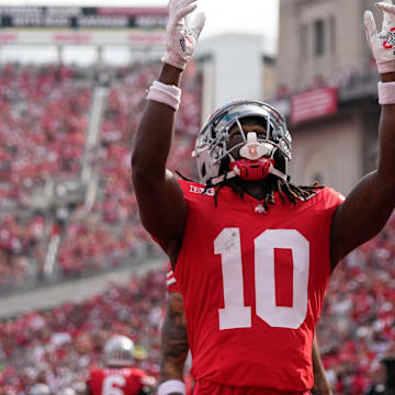 Aug 31, 2024; Columbus, OH, USA; Ohio State Buckeyes cornerback Denzel Burke (10) celebrates an interception during the first half of the NCAA football game against the Akron Zips at Ohio Stadium.